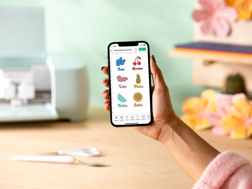 Woman's hands feeding material into Cricut Joy Xtra